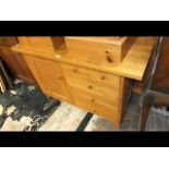 An oak sideboard with drawers beside cupboard - wi