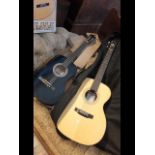 A Recording King acoustic guitar together with a P