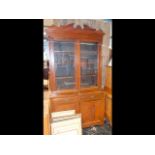 A late Victorian walnut bookcase with glazed upper