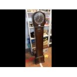 A 1930's oak cased grandmother clock