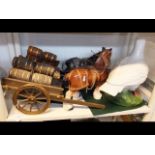 Two ceramic cart horses with drays together with a