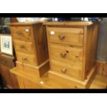 A pair of three drawer pine bedside cabinets