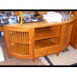 A honey-stained hardwood sideboard with open-slat