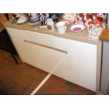 An oak effect sideboard with three cupboards under