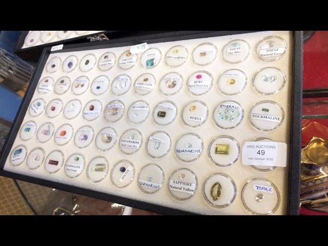 A tray containing various collectable gems, includ