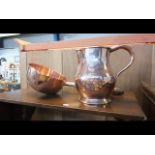An antique copper jug together with handled pan