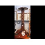 A torchere together with antique bedroom chair