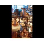 A set of six antique graduated copper jugs