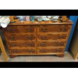 A yew wood chest of eight drawers