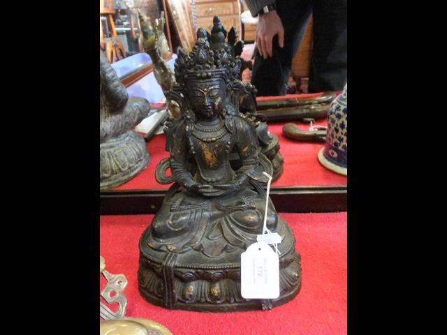 An antique gilt bronze buddha - 29cms high