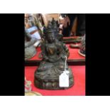 An antique gilt bronze buddha - 29cms high