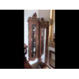 A pair of Chinese style wooden framed hall mirrors