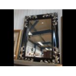 A decorative bevelled wall mirror