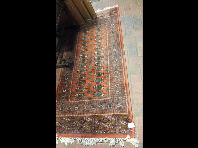 A Middle Eastern style runner with geometric borde