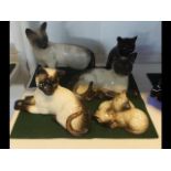 A selection of Beswick cat ornaments