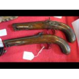 A pair of early 19th century dueling pistols, sign