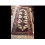 A Middle Eastern style runner with geometric borde