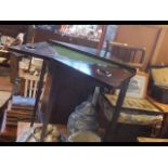 An antique fold over games table together with an