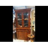 A Victorina bookcase with glazed upper section, dr