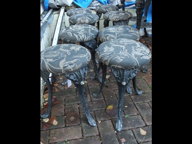 A set of eight cast metal pub stools