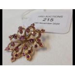 A ruby set 18ct gold star brooch