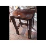 A nest of three mahogany occasional tables