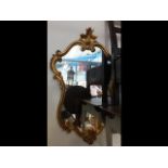 An antique style gilt framed wall mirror - 95cms