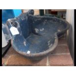 A cast metal water trough