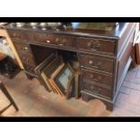 A reproduction pedestal desk