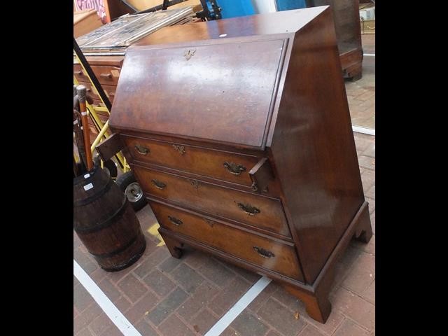 A walnut bureau with drawers below