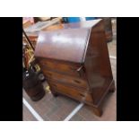 A walnut bureau with drawers below