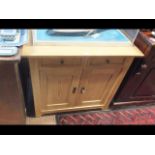 A pine sideboard with drawers and cupboards