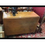 A 19th century mahogany drop leaf dining table on