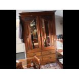 A late Victorian two door wardrobe with four drawe