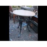 A circular cast iron and wooden pub table