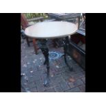 A circular cast iron and wooden pub table