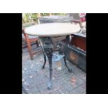 A circular cast iron and wooden pub table