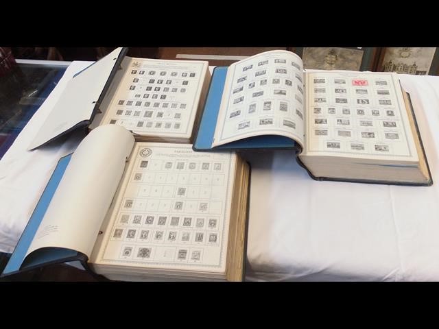 Three large global stamp albums containing a small