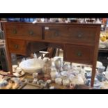 An Edwardian mahogany desk with four drawers to th