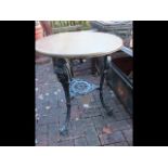 A circular cast iron and wooden pub table