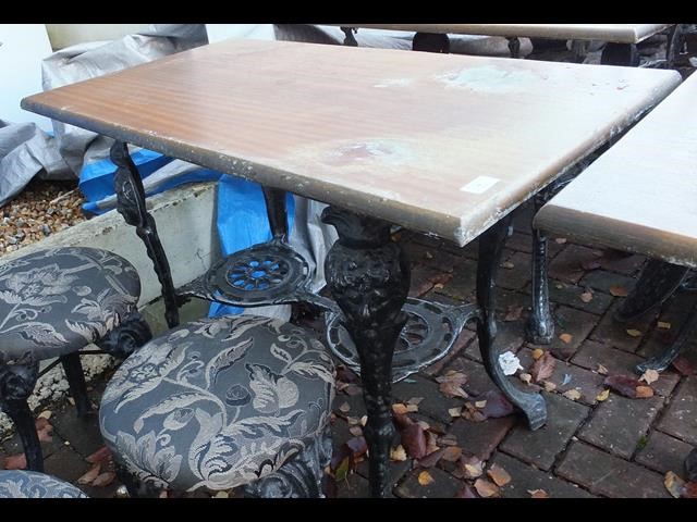 A cast metal and wooden pub/garden table