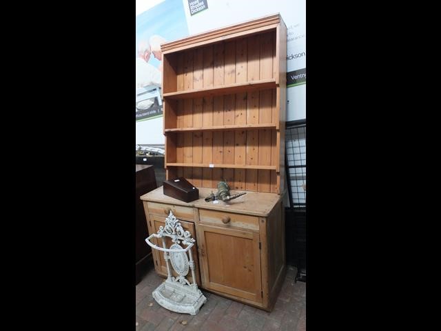 A pine dresser with associated plate rack over