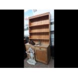 A pine dresser with associated plate rack over