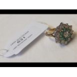 A diamond and emerald ring in 18ct setting - appro