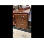 A three drawer mahogany bedside chest