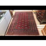 A Middle Eastern rug with red ground and geometric