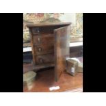 An antique four drawer collectors chest with panel