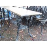 A cast metal and wooden pub/garden table