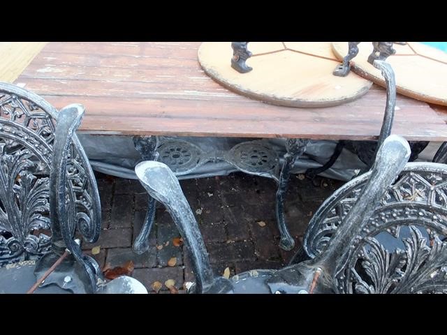 A cast metal and wooden garden/pub table