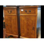 A pair of yew wood bedside cabinets